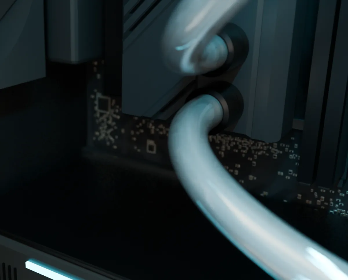 Nahaufnahme des fertigen Kreislaufs: zwei weiche, klare Schläuche an den Anschlüssen des CPU-Kühlers, cyan beleuchtet